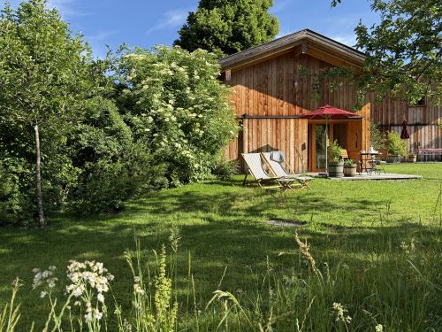 Wohnzimmer mit Sitzecke im Hollerhäusl | Lohei - Chalets im Chiemgau Wohnzimmer mit Sitzecke im Hollerhäusl | Lohei - Chalets im Chiemgau